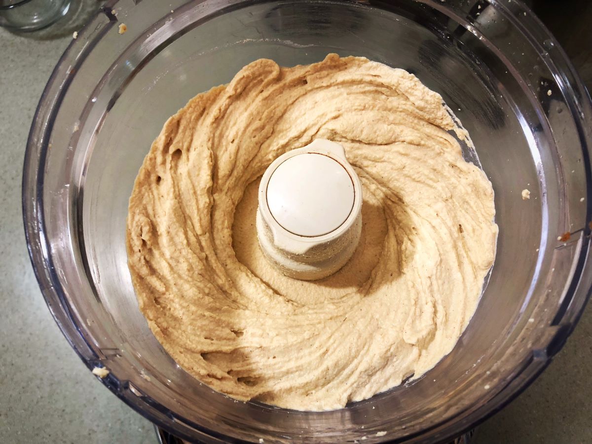 Vegan strawberry cream cheese being blended in a food processor