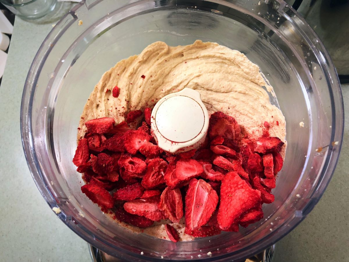 Vegan strawberry cream cheese ingredients in a food processor