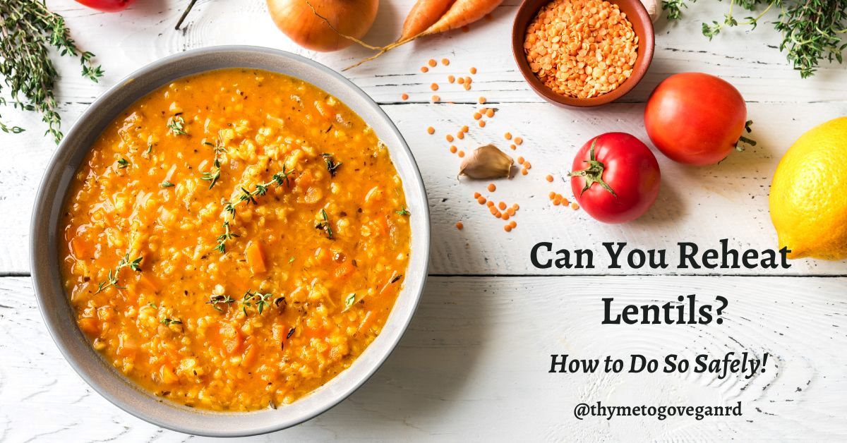 Bowl of lentil curry on a gray table with text overlay reading "can you reheat lentils? how to do so safely"