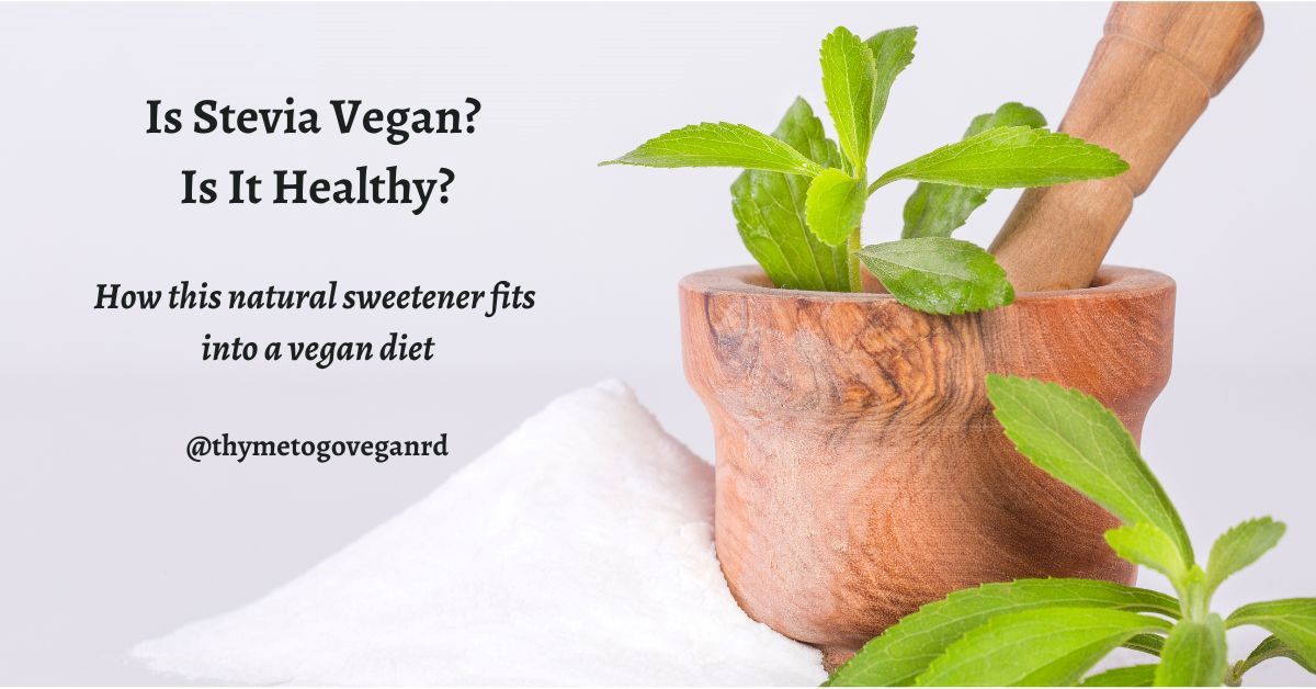 Photo of green stevia leaves in a mortar and pestle with granulated stevia next to it, and black text overlay reading "is stevia vegan? is it healthy?"