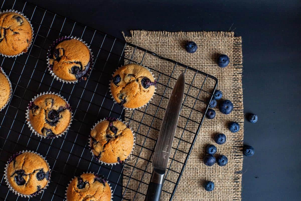Gluten-free blueberry muffins cooling on a rack